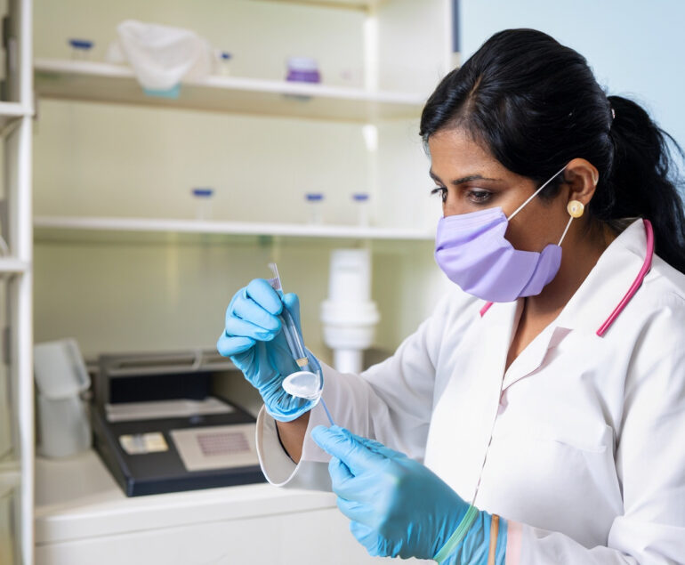 Indian female doctor checking for fewer in a pathology lab